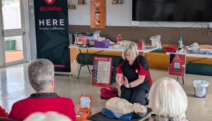 St John trainer demonstrating CPR techniques to older members of the community.